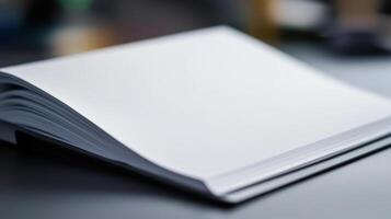 An open book on a table with a blank page photo
