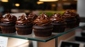 Delicious chocolate cupcakes topped with rich ganache frosting photo