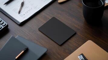 minimalist workspace featuring blank card on wooden desk, surrounded by office supplies photo