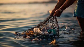 fisherman pulls up net filled with plastic waste, highlighting pollution photo