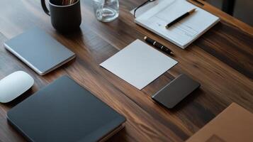modern workspace with stationery, notebooks, and coffee mug on wooden desk photo