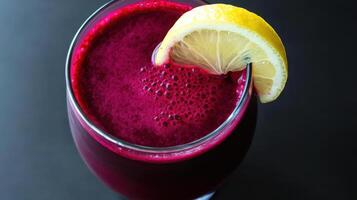 A glass of beet juice with a lemon wedge photo