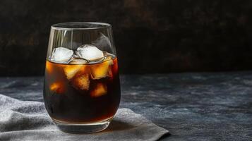 Iced coffee in a tall glass with ice cubes photo