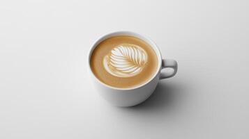 A cup of coffee with a leaf design on top photo