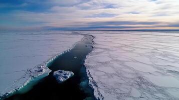 Aerial view of frozen landscape with winding waterway through ice photo