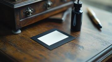 A black and white square is sitting on top of a wooden desk photo