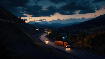 A truck driving down a road at dusk photo