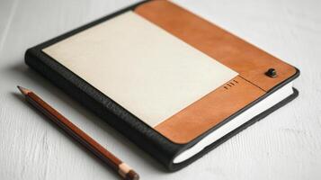 leather covered journal with pencil beside it, perfect for notes photo
