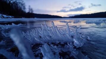 Frozen lake with ice formations at sunset, creating serene atmosphere photo
