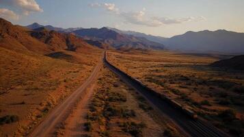 Aerial view of coal train traveling through desert landscape at sunset photo