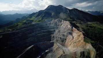 An aerial view of a quarry with mountains in the background photo