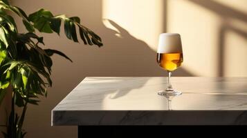 Aesthetic beer glass on marble table with plant in soft light photo