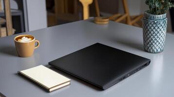 A laptop and a cup of coffee on a table photo
