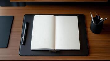 Notebook, pen, and pencils on a desk photo