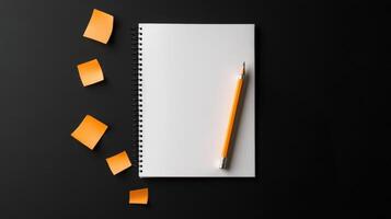 Notebook with pencil and sticky notes on black background photo