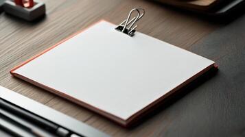 Blank notepad on desk with pen and pencil photo