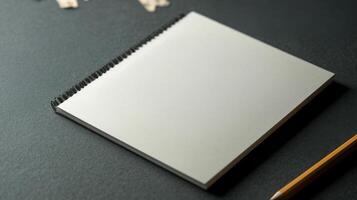 blank sketchbook with pencil on dark surface, ready for creativity photo