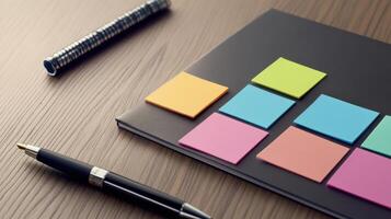 A notebook with colorful sticky notes and pen on a wooden table photo