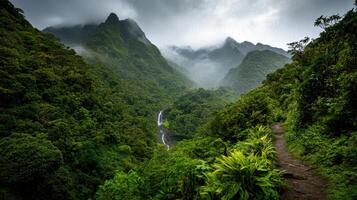 Lush green mountains with mist and waterfall in valley photo