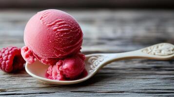 A scoop of ice cream with a raspberry on top photo