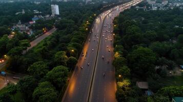 Aerial view of busy highway surrounded by greenery at dusk photo