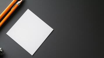 blank page on dark desk with pencils and clip photo