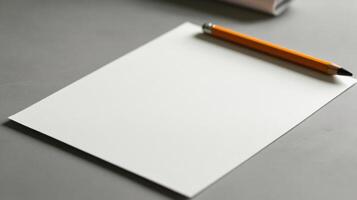 A white sheet of paper with an orange pencil on top photo