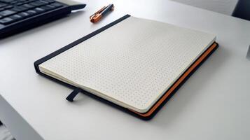 A notebook on a desk with a keyboard and mouse photo