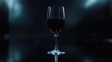 A glass of red wine on a dark background photo