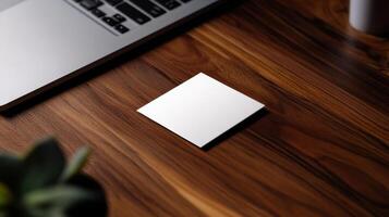 modern business card on wooden desk near laptop photo