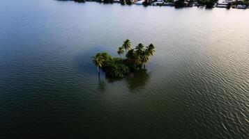 small island surrounded by rising sea levels and water photo