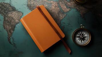 travel journal and compass on vintage map background photo