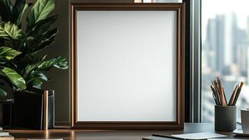 Mock up of a blank white frame on a desk with a plant and a computer photo