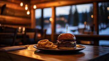 steaming hot burger with onion rings on wooden table photo
