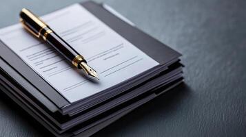 Neatly organized business documents with fountain pen photo