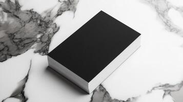 stack of minimalistic black business cards on marble photo