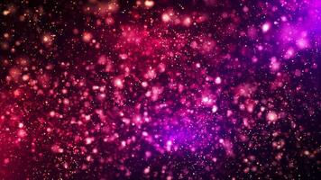 Abstract animation concept of colored particles for celebrating birthdays and holidays. 4k loop bokeh background with light particles on a dark background. Animation footage video