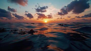 sunset over ocean with waves and clouds reflecting beauty photo