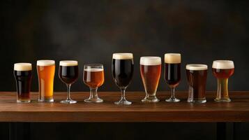 A variety of beer glasses on a wooden table photo