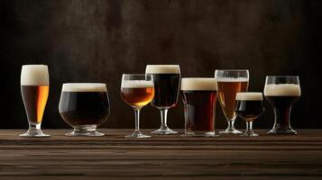 Various types of beer glasses on a wooden table photo