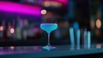 A blue cocktail sitting on a bar counter photo