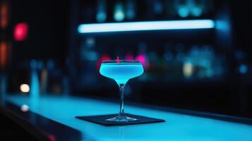 vibrant blue lagoon cocktail glowing in dark bar photo