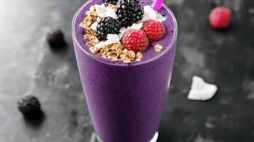 A purple smoothie with berries and granola photo