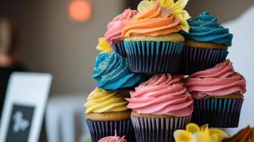 A tower of cupcakes with colorful frosting photo