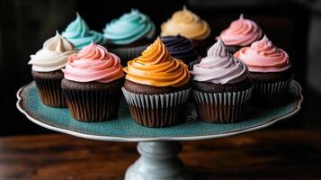 Vibrant cupcakes with pastel frosting on decorative plate photo