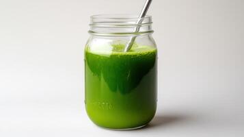 Fresh green juice in jar with metal straw photo