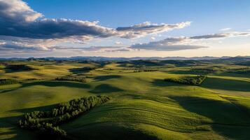 vast green landscape with rolling hills and distant mountains photo