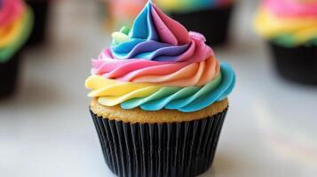 Whimsical cupcake with rainbow frosting and black wrapper photo