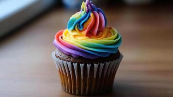 A cupcake with rainbow frosting on top photo