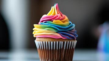 A cupcake with rainbow frosting on top photo